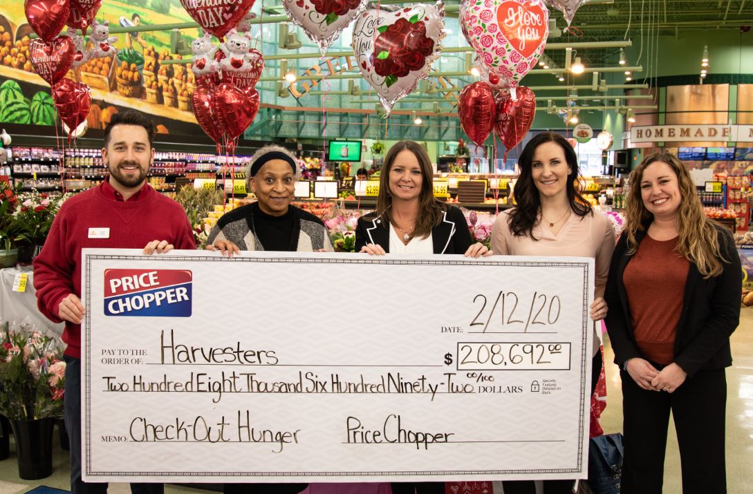 Price Chopper and Harvesters representatives holding check